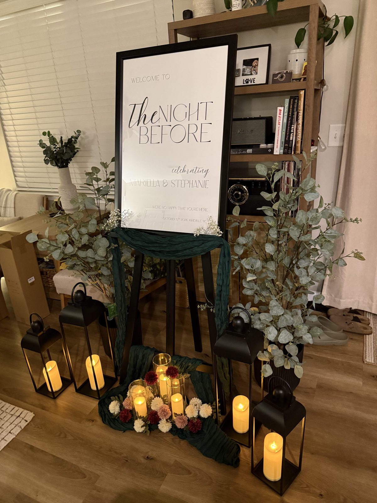 Night Before entry sign with lanterns and florals