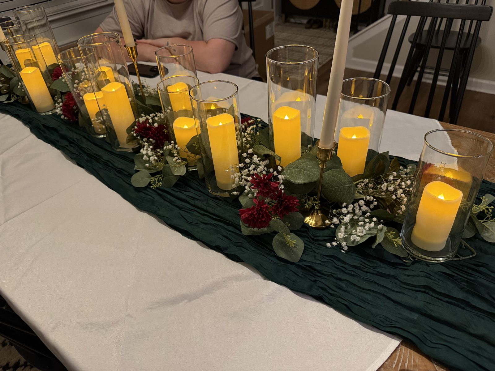 Rectangle table dressed with eucalyptus garland, burgundy florals and votives